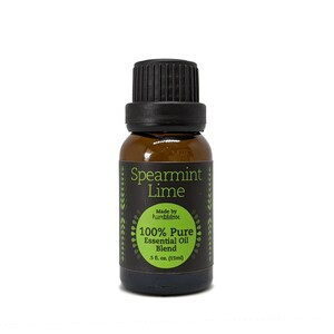 May include: A brown glass bottle with a black cap, labeled "Spearmint Lime 100% Pure Essential Oil Blend" with a green and black design. The bottle contains 5 fl. oz. (15 ml) of essential oil.
