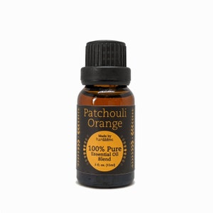 May include: A small amber glass bottle with a black cap, labeled "Patchouli Orange 100% Pure Essential Oil Blend" with a gold and black design. Made by humblelove. 0.5 fl. oz. (15ml)