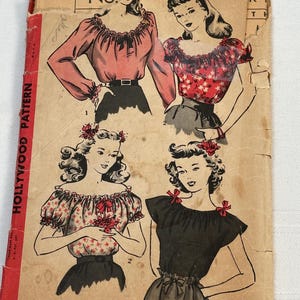 May include: Vintage Hollywood Pattern sewing pattern. The cover shows illustrations of four different blouses. The blouses are in various colours and styles, including a red floral print and a black top. The text "A SEW-SIMPLE DESIGN" is visible.
