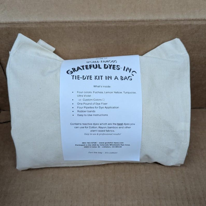 May include: A white cotton tie-dye kit in a bag. The kit includes four colors: fuchsia, lemon yellow, turquoise, and ultra violet. It also contains dye fixer, pipettes, and rubber bands. The bag has the text "Grateful Dyes-Inc Tie-Dye Kit in a Bag."