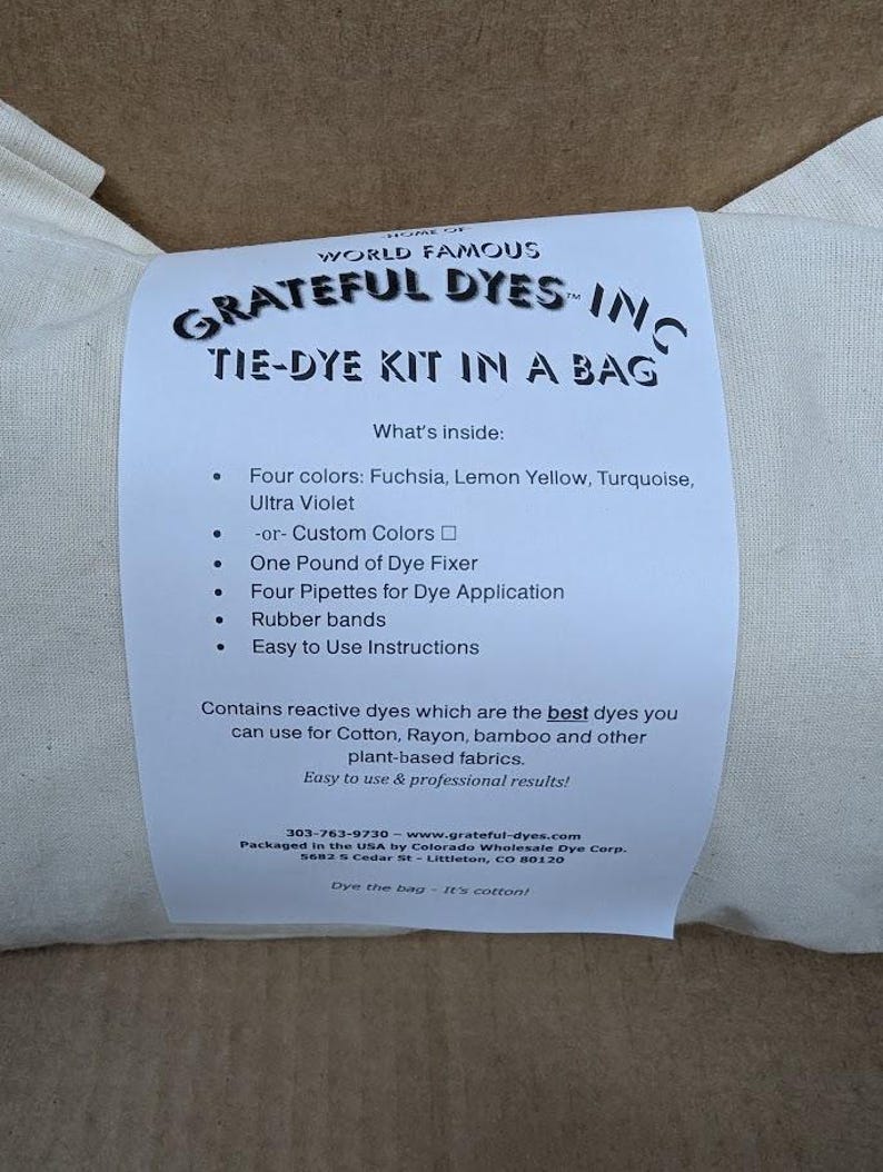 May include: A tie-dye kit in a bag from Grateful Dyes, Inc. The kit includes four colors: fuchsia, lemon yellow, turquoise, and ultra violet, plus dye fixer, pipettes, rubber bands, and instructions. The kit is designed for use on cotton, rayon, bamboo, and other plant-based fabrics.