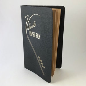 May include: A black leather-bound file folder with gold lettering that reads "Valuable Paper File" and "For Home and Office".