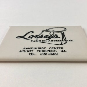 May include: White card with black text and a drawing of a purse. The text reads "Lorsey's Fashion Accessories", "Randhurst Center", "Mount Prospect, Ill.", and "Tel. 392-3600".