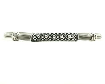Slim silver bead with design guitar string bracelet
