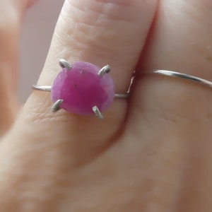 May include: A set of three ceramic mugs with a speckled, matte finish. The mugs are in shades of cream, light gray, and dark gray. Each mug has a simple, minimalist design and a rounded handle.