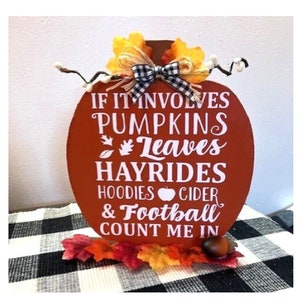 If it involves pumpkins leaves hayrides hoodies cider & football count me in pumpkin shaped freestanding sign for Fall decor