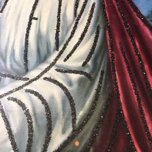 May include: A close-up of a painting of a person wearing a white robe with black trim and a red robe with black trim. The painting is done in a traditional style and has a vintage feel.