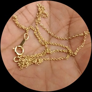 May include: A gold chain necklace with a lobster clasp closure.