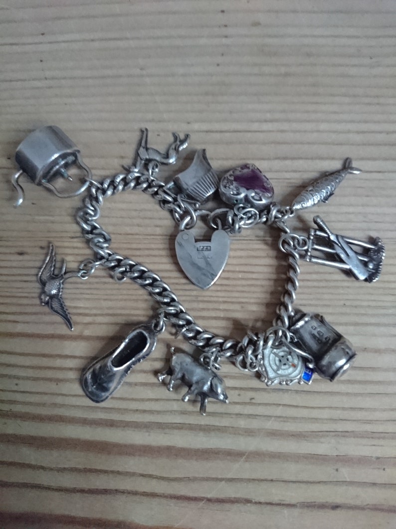 Vintage sterling silver charm bracelet with eleven charms