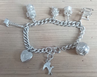 Vintage sterling silver charm bracelet with eight charms