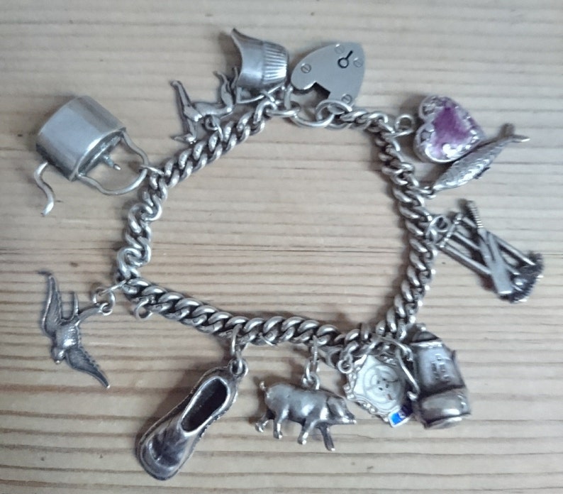 Vintage sterling silver charm bracelet with eleven charms