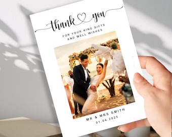 May include: A white wedding thank you card with the words "thank you" in elegant script, a heart symbol, and the text "FOR YOUR KIND GIFTS AND WELL WISHES." The card features a photo of a couple and the names "MR & MRS SMITH" and the date "01.04.2025."
