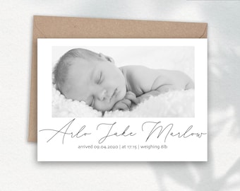May include: A black and white birth announcement card featuring a sleeping baby. The card includes the baby's name, birth date, time, and weight. The card is inside a brown envelope. The words "DESIGN 5" are in the upper right corner.