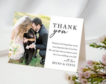 May include: A folded wedding thank you card with a photograph of a couple and their dog. The card reads "THANK you" in elegant script, followed by a message and the names "BECKY & STEVE". The design is labeled "DESIGN 9".