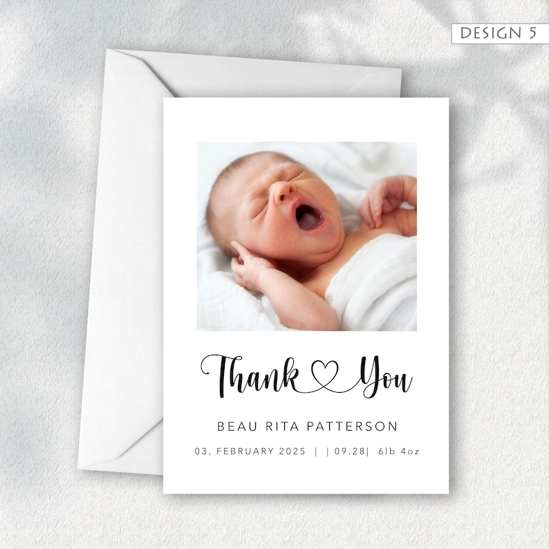 May include: A white thank you card with a photo of a newborn baby yawning. The card includes the text "Thank You" in a script font, along with the baby's name, birthdate, and weight. The card is accompanied by a white envelope.