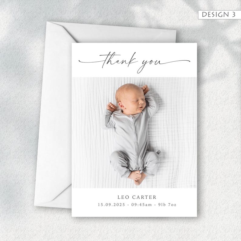 May include: A white card with a baby photo and the words "thank you" in elegant script. The baby is wearing a gray onesie. The card includes the baby's name, birthdate, time, and weight. A white envelope is included.