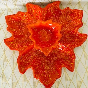 May include: Orange and yellow ceramic leaf-shaped serving dish with three separate bowls. The dish is decorated with a speckled pattern.