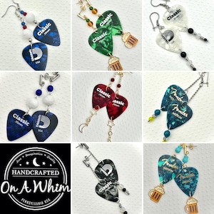 May include: A collection of handcrafted earrings featuring guitar pick designs. The earrings showcase various colors and patterns, including blue, green, red, and white. Some earrings have beer mug charms and decorative beads.
