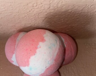 Large 2 1/2 inch pink colored bubble bomb, lots of bubbles, solid bubble bath, purple bath