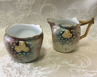 Conjunto de cremeira e açucareiro em porcelana de Limoges, pintado à mão com motivos florais, B. Denham, França.