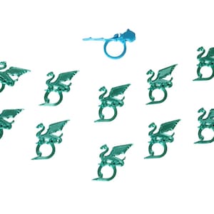 May include: Ten teal green dragon-shaped ring holders and one light blue dragon-shaped ring holder.