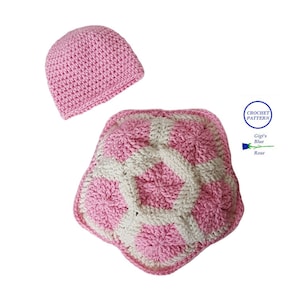 May include: A pink crocheted hat and a pink and white crocheted turtle. The turtle is flat and has a star shape. The crochet pattern is called "Gigi's Blue Rose".
