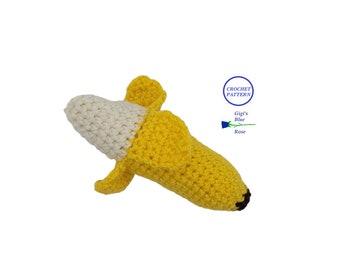 May include: Crocheted banana toy with a white stem and yellow body. The toy is made with yarn and has a brown crocheted stem.