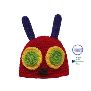 Peut inclure: Chapeau en crochet pour bébé en forme de chenille avec du fil rouge, jaune, vert et bleu. Le chapeau a deux longues antennes bleues et deux grands yeux en fil jaune, vert et rouge.