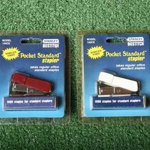 May include: Two packaged Stanley Bostitch Pocket Standard staplers. One is red and the other is white. Both staplers are labeled "World's First" and take regular office standard staples.