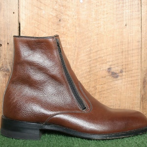 May include: A brown leather ankle boot with a zipper up the side.