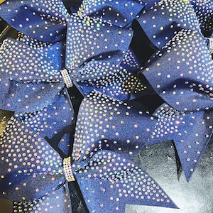 Ribbon bonded cheer bow in your color choice with rhinestone fade pattern