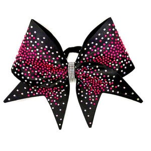 May include: A large black hair bow with a pink and white rhinestone design. The bow is decorated with a gradient of pink rhinestones, transitioning to white rhinestones. A silver rhinestone band is in the center.