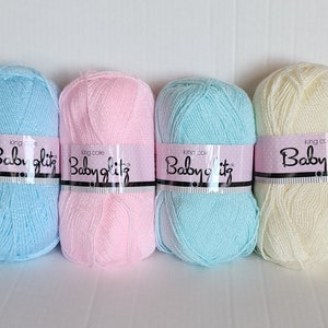May include: Four skeins of Babyglitz yarn in light blue, pink, turquoise, and cream colors. The yarn is a soft, sparkly, and lightweight acrylic blend.