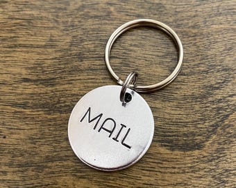 May include: Silver key chain with a round tag that says "MAIL" on it.