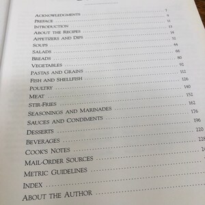 May include: A table of contents for a cookbook with page numbers for each section, including appetizers, soups, salads, breads, vegetables, pastas, fish, poultry, meat, stir-fries, seasonings, sauces, desserts, beverages, cook's notes, mail-order sources, metric guidelines, index, and about the author.