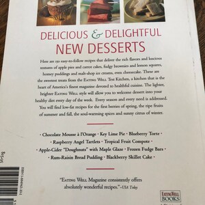 May include: A book cover with a white background and the title "Delicious & Delightful New Desserts" in black text. The cover features a photo of a small apple pie and a stack of lemon squares. The book is from Eating Well Books, a division of EW Communications L.P.