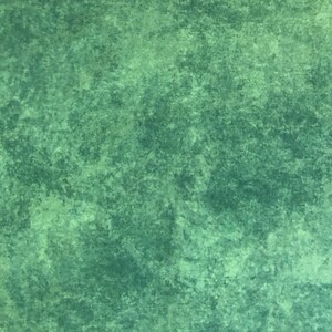 May include: A textured green background with a mottled, uneven surface.