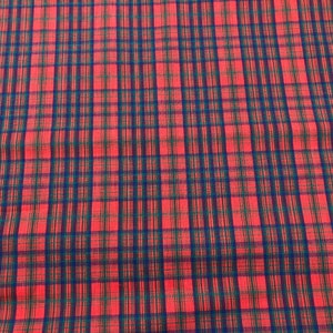 May include: Red fabric with a blue and green plaid pattern.