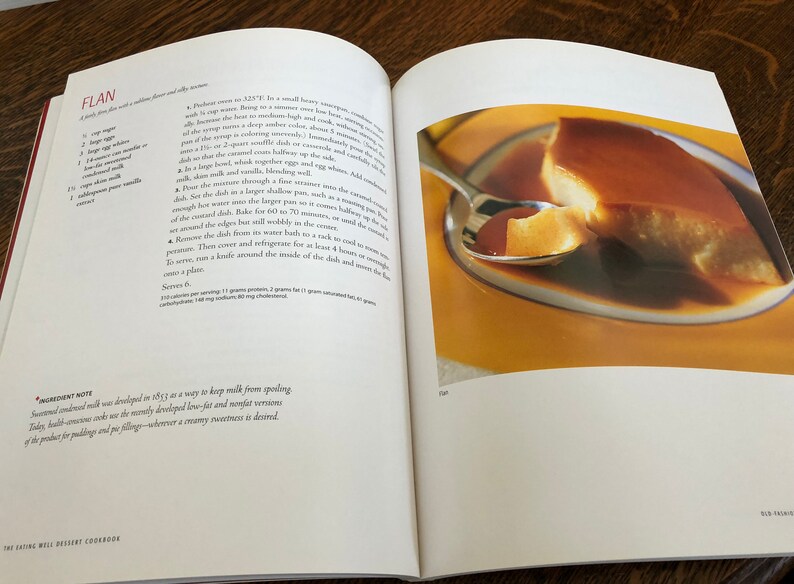May include: A close-up of a flan dessert on a yellow plate. The flan is a light yellow color and has a smooth, creamy texture. The flan is topped with a caramel sauce. The flan is being scooped up with a silver spoon.