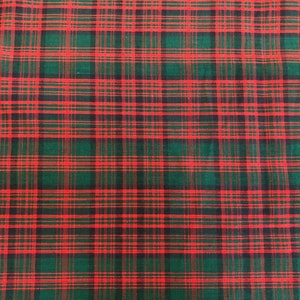 May include: Red and green plaid fabric with a woven texture.