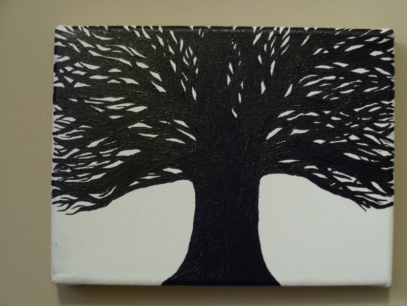 May include: Black and white painting of a tree with a thick trunk and branches that spread out wide. The tree is painted on a white canvas.
