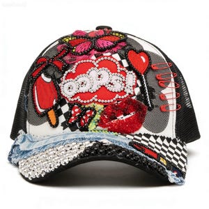 May include: A black and white trucker hat with a mesh back and a curved brim. The front panel is decorated with a red cloud that says "OOOPS!" in silver rhinestones, a red popsicle, and a sequined red lip design.