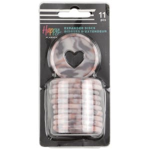 May include: A pack of 11 marble-patterned Happy Planner expander discs. The discs are pink, white, and grey with a black heart cutout. The packaging is black with white text that reads "Happy Planner Expander Discs Disques d'Extendeur 11 pcs".