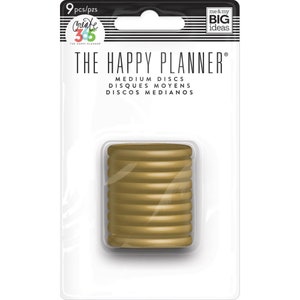 以下が含まれることがあります： The Happy Planner用のゴールドの中型プランナーディスク9個パック。パッケージには、「The Happy Planner」のブランド名と「Medium Discs、Disques Moyens、Discos Medianos」のテキストが表示されています。