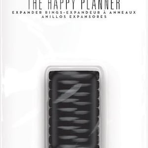 May include: A package of 9 black planner ring expanders for The Happy Planner. The package is labeled "The Happy Planner" and "Expander Rings - Expandeur à Anneaux - Anillos Expansores".