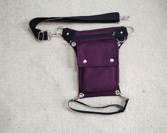 Festival bag with a belt with a swivel clasp around the waist and a leg strap on the thigh