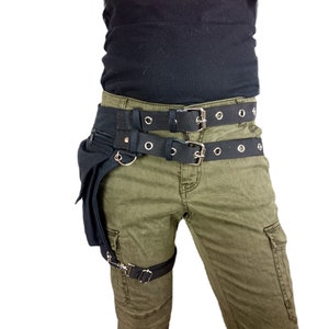 Utility belt with a thigh strap to attach the bag to your leg, made of black organic cotton with a sturdy belt buckle