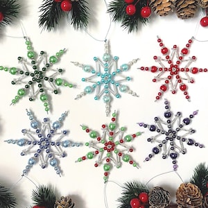 May include: A white ceramic mug with a black handle and the text "But First, Coffee" in a black, handwritten-style font. The mug is on a white surface.