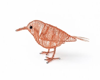May include: A bird sculpture crafted from thin copper wire, featuring a rounded body, a pointed beak, and a single small black bead for an eye. The wire is wrapped in a dense, layered pattern to form the wings and tail, with thin wire legs.