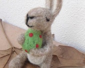 Easter Bunny, needlefelted, holding a green easteregg